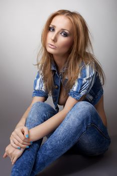 Beautiful girl sit in jeans and jacket on naked body