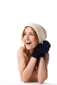 Happy blond woman in black mitten and white cap