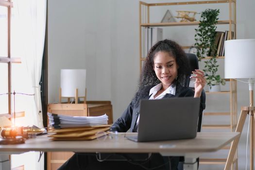 cheerful smiling business woman sitting at the office happy african american businessman in office.