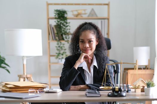 Portrait of young female Lawyer or attorney working in the office, smiling and looking at camera..