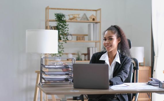 cheerful smiling business woman sitting at the office happy african american businessman in office.