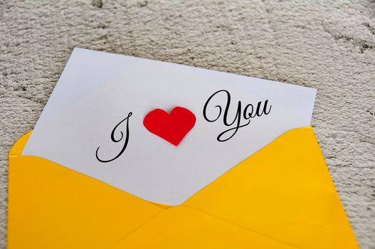 I love you text on notepad in yellow envelope. Romance and relationship concept.