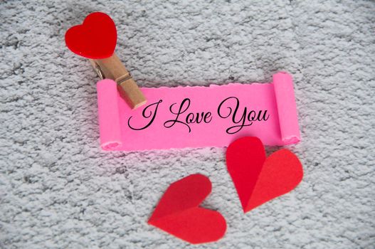 I love you text on torn pink paper with keyboard background. Romance and relationship concept.