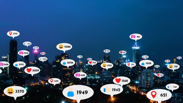 Social media icons fly over city downtown showing people reciprocity connection through social network application platform . Concept for online community and social media marketing strategy .