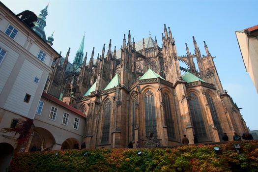 Historical Prague cafedral and tourist walk around at autumn sunset