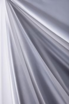 white transparent silk cloth waves background texture close-up