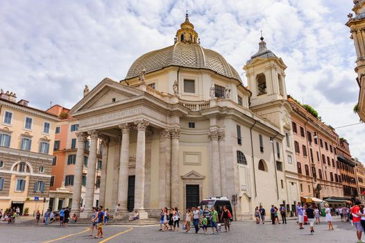 Rome, Italy, August 2014: View of piazza del Popolo in Rome crowded with tourists. Santa Maria in Montesanto and Santa Maria dei Miracoli basilics