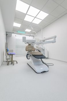 Interior of white modern dentistry medical room with special equipment