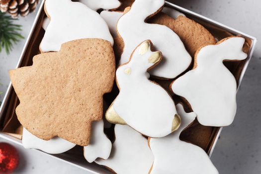 A box of Christmas cookies in the form of a rabbit and a Christmas tree on the table with New Year's decor. copy space. close-up