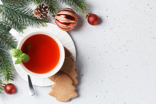 A cup of tea with Christmas cookies on a table with New Year's decor. copy space