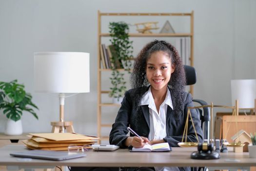 Portrait of young female Lawyer or attorney working in the office, smiling and looking at camera..