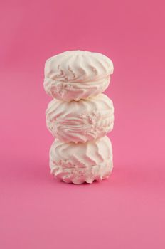 Russian marshmallow white zephyr on pink paper background
