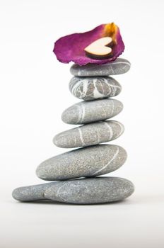 Balanced gray zen pebbles on white background. Zen stones. Spa and healthcare concept. 