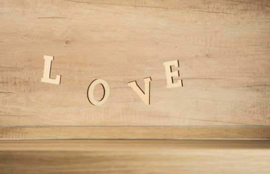 Flying in the form of word love on a wooden background. Happy Valentines Day