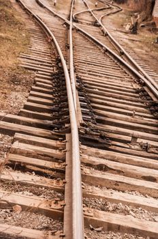 Fragment of a railway track with rails and sleepers in the countryside