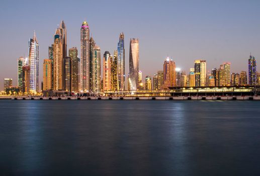 View of A Dubai Marina after sunset. Shot made from Palm Jumeirah, man made island. Dubai, UAE. Outdoors.