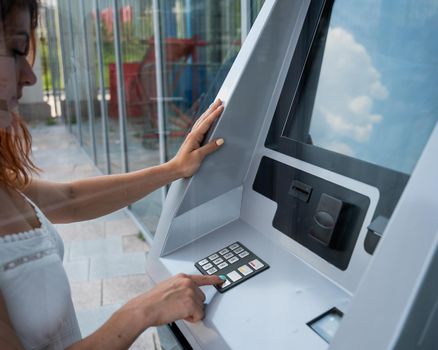 Caucasian woman buying tickets from the machine