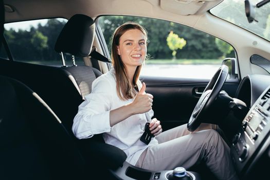 The woman behind the wheel pinches the seat belt
