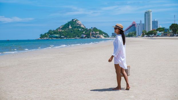 Asian women walking on the beach in the morning at Takiab Beach Huahin Thailand