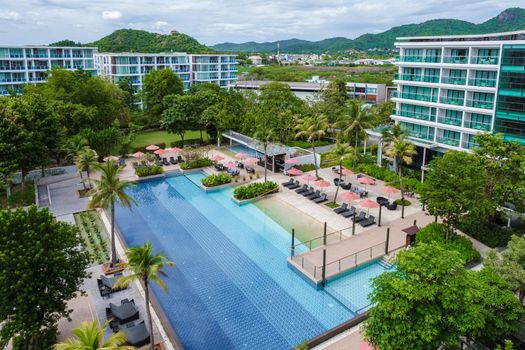 Amari Huahin Thailand, Aerial view at the pool with sunbeds, luxury resort with swimming pool and sunbed by the ocean at a luxury resort