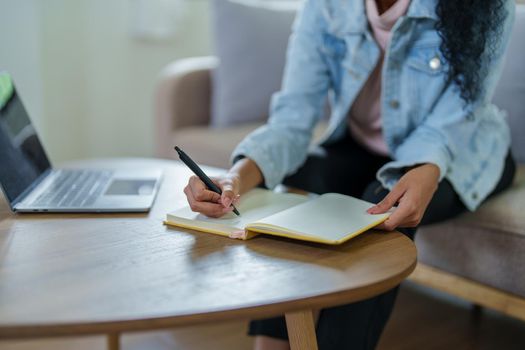 Portrait of African Americans using notebooks, pens to take notes and computers. to study through the Internet, online e learning concept