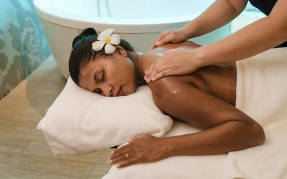 Asian women on a massage table, Asian women getting a Thai massage at a luxury hotel in Thailand.