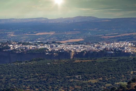 Ronda Spain cityscape at sunset with the sun about to set.