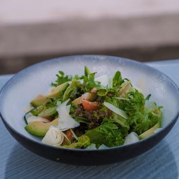 Greek salad with avocado on a plate.colorful salad fresh salad