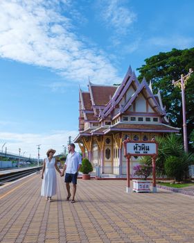 A couple of men and women are walking at Hua Hin train station in Thailand. Asian women and Caucasian men walking at the train station of Huahin