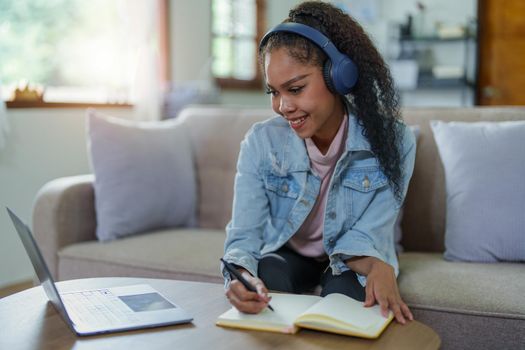 Portrait of African Americans using notebooks, pens to take notes and computers. to study through the Internet, online e learning concept