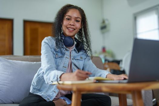 Portrait of African Americans using notebooks, pens to take notes and computers. to study through the Internet, online e learning concept