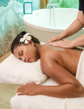 Asian women on a massage table, Asian women getting a Thai massage at a luxury hotel in Thailand.
