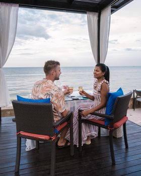 Dinner by candlelight on the beach in Thailand. Romantic dinner on the beach. Couple men and women dinner on the beach