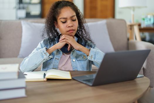 Portrait of African Americans using computers and notebooks to study online and showing doubtful faces at lessons they have learned.