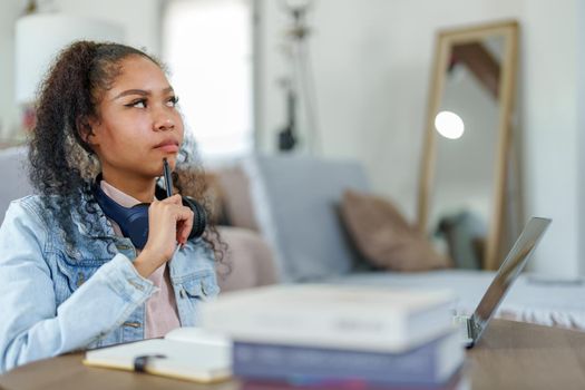 Portrait of African Americans using computers and notebooks to study online and showing doubtful faces at lessons they have learned.