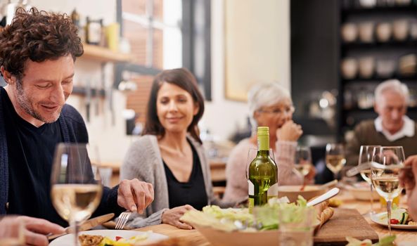 Sitting down to family dinner. a family sitting down to dinner