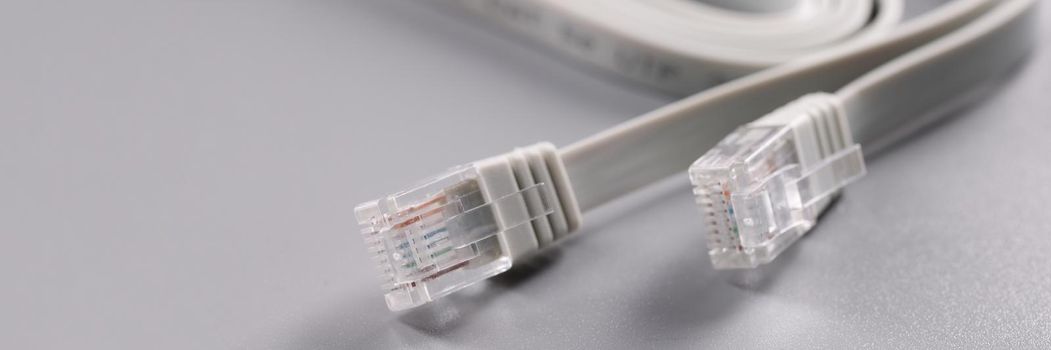 Closeup of rj45 cable on gray background. internet connection concept