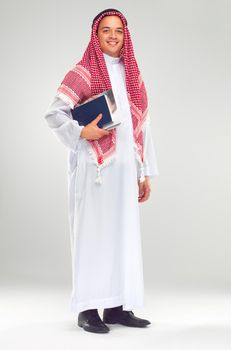 Tradition and education are of equal importance. Studio portrait of a middle-eastern male student