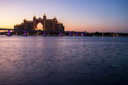 Atlantis, popular five star hotel in Dubai, UAE at night. Monorail leading to the hotel also can be seen in the picture. Outdoor.