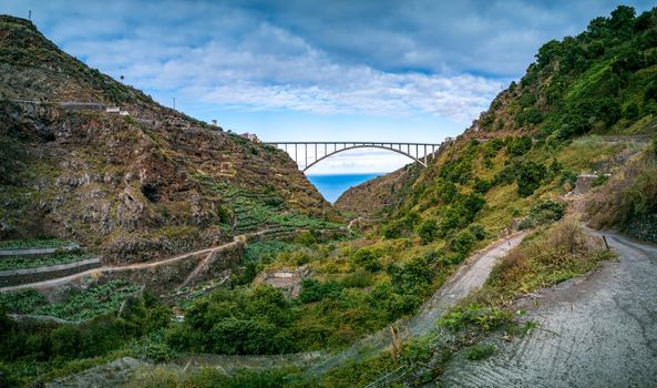 Spectacular arch bridge and old curved road