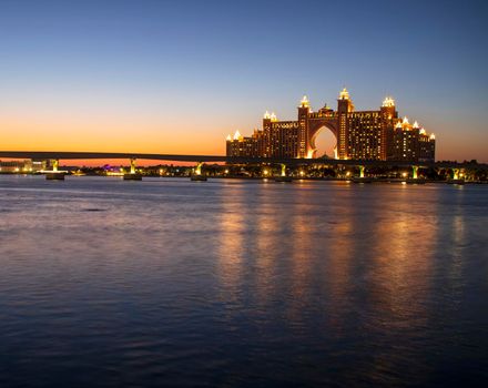 Atlantis, popular five star hotel in Dubai, UAE at night. Monorail leading to the hotel also can be seen in the picture. Outdoor.