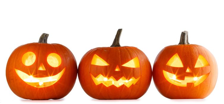 Three Halloween glowing lantern pumpkins in a row isolated on white background