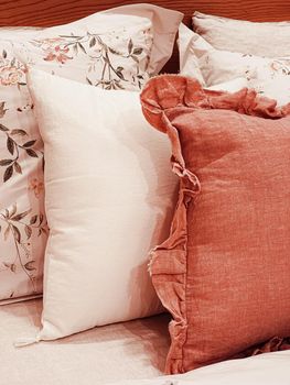 Vintage countryside style bedding with floral pattern on wooden bed in bedroom, interior design detail