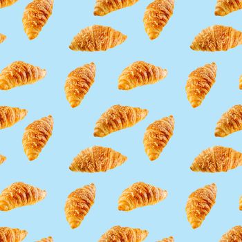 seamless pattern made from Fresh croissant isolated on blue background. Bakery pattern with baked croissant with cheese.