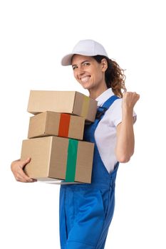 Portrait of delivery woman in white cap, t-shirt giving order boxes isolated on white background. Female courier step, cardboard box. Receiving package.