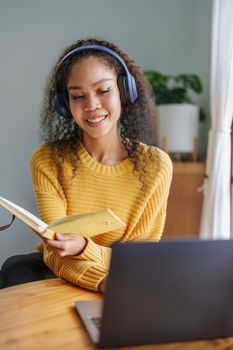 Portrait of African Americans using notebooks, pens to take notes and computers. to study through the Internet, online e learning concept