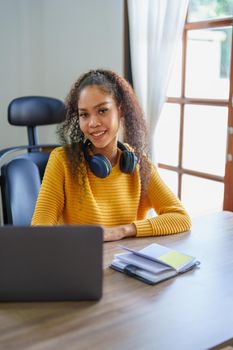 Portrait of African Americans using notebooks, pens to take notes and computers. to study through the Internet, online e learning concept