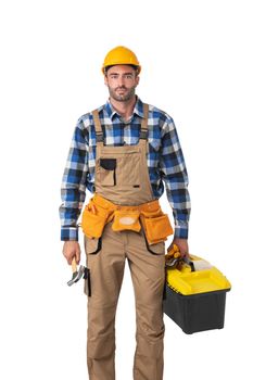 Contractor worker in coveralls and yellow hardhat with toolbox isolated on white background