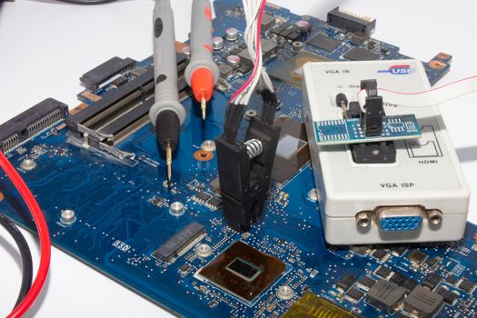 Computer repair service. Engineer repairing laptop mainboard. Hardware developer measure electronic components. 