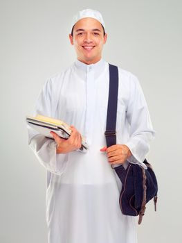 Education is essential. Studio portrait of a young arabic man carrying books